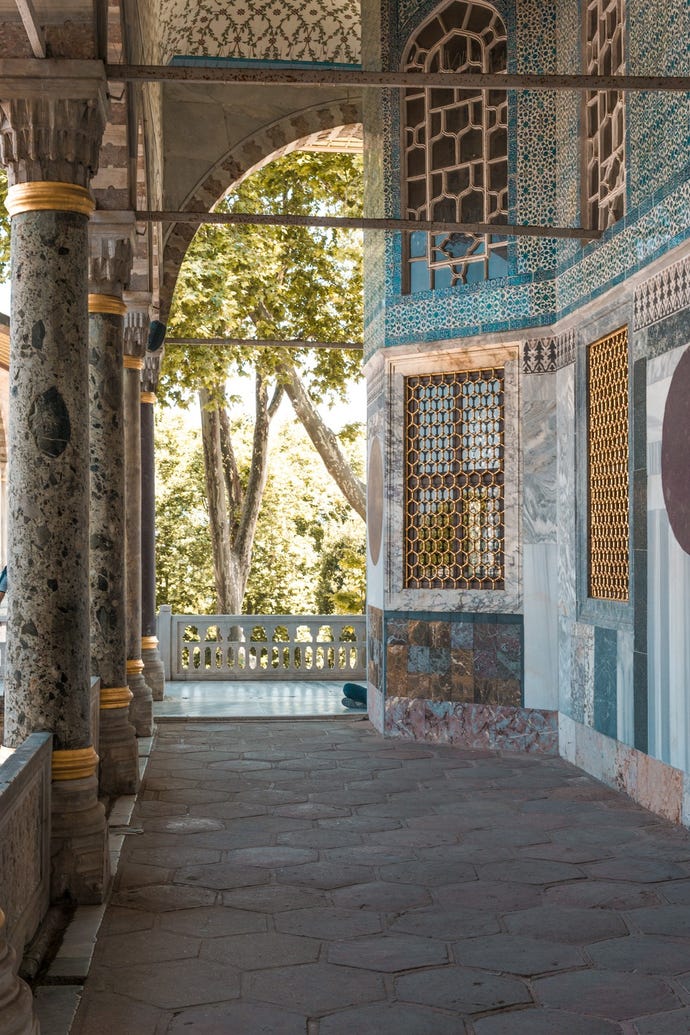 A view within the verdant gardens and ornate pavilions of Topkapi Palace