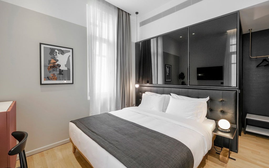 Minimalist medium hotel room at The Modernist Thessaloniki, featuring sleek design, neutral color palette, and contemporary furnishings with soft natural light