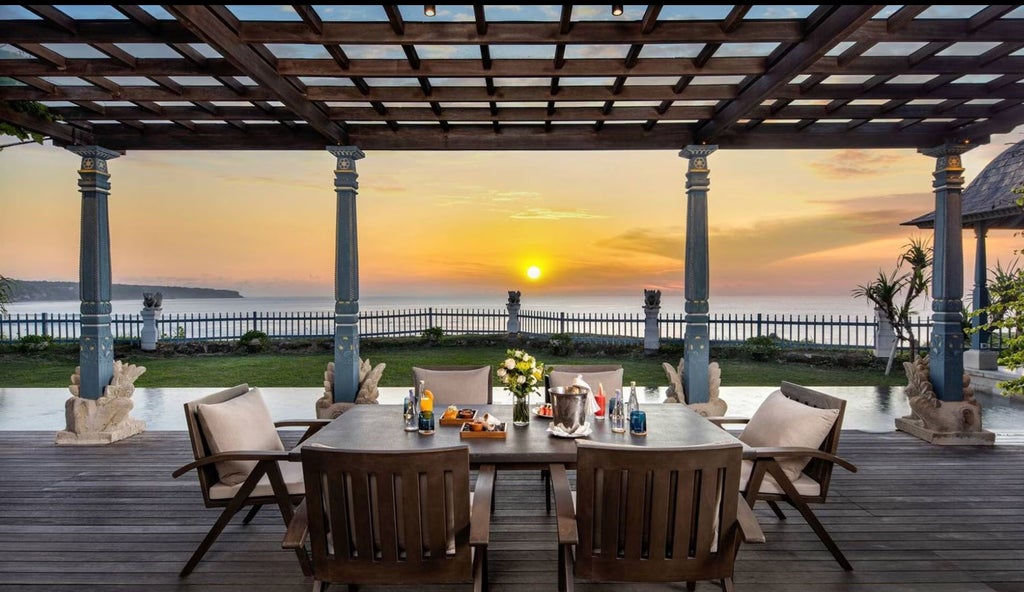 Spacious ocean villa bedroom with floor-to-ceiling windows, modern Balinese decor, private infinity pool overlooking tropical landscape