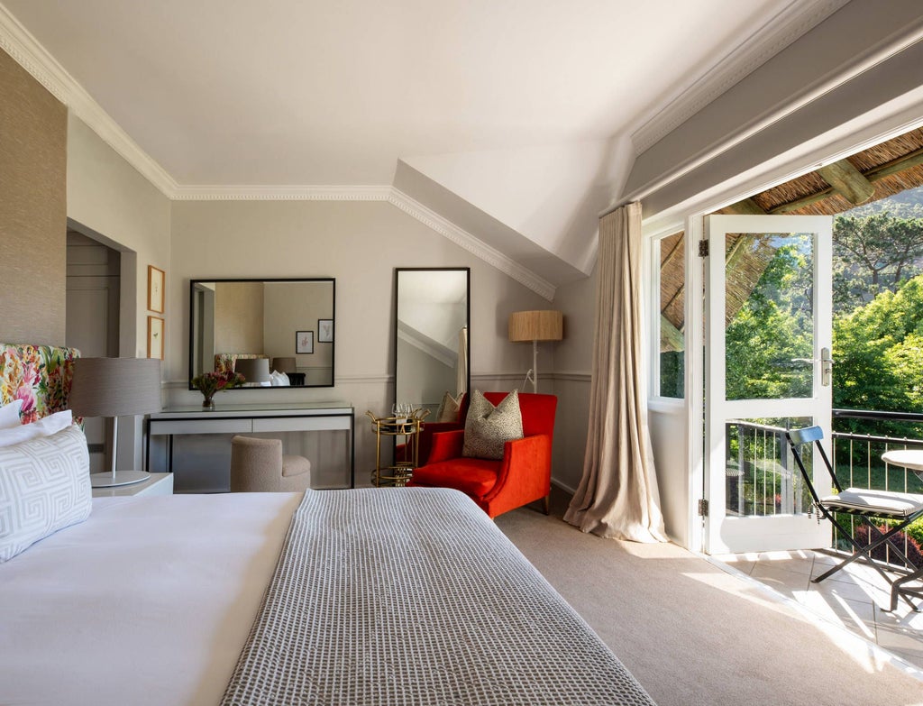 Elegant Shiraz Room at scenset's Mont Rochelle, featuring plush king bed, rich wooden furnishings, and warm South African wine country ambiance with soft natural lighting