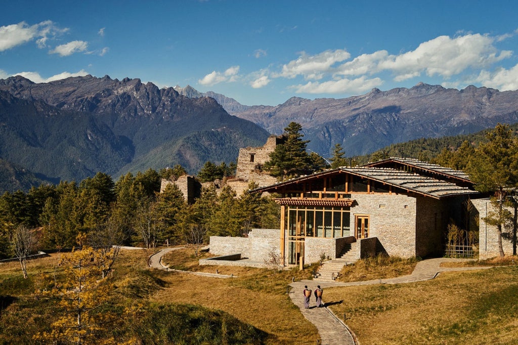 Luxurious mountain lodge with traditional Bhutanese architecture nestled in pine forests, featuring stone walls and sweeping valley views