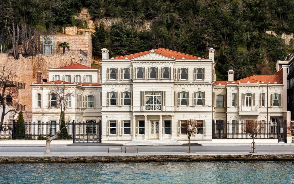 Elegant historic Ottoman-era mansion with luxurious Six Scenset hotel exterior, featuring stone facades, lush gardens, and traditional architectural details in Istanbul