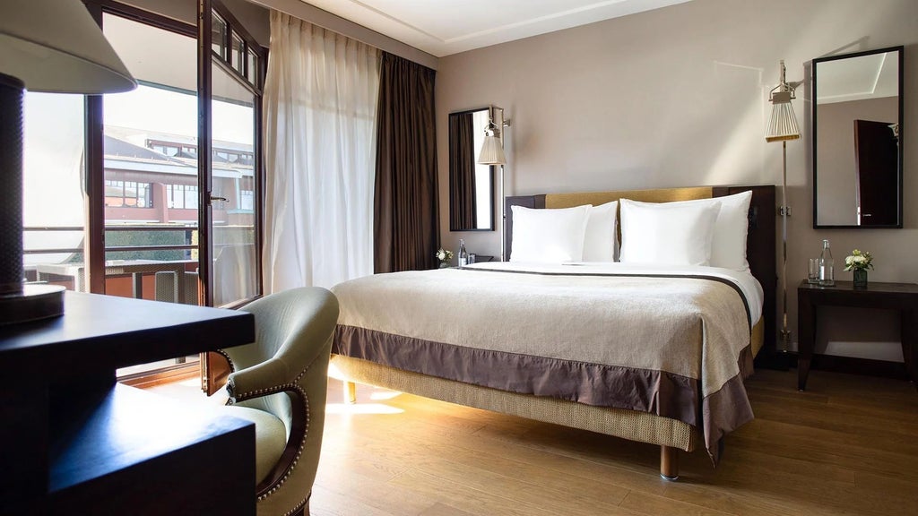 Elegant executive hotel room with modern design, lake view, contemporary furnishings, neutral tones, and floor-to-ceiling windows at La Réserve Genève Hotel and Spa