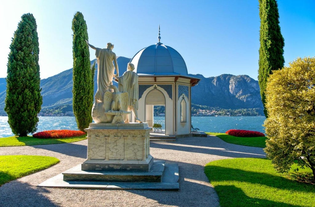 Ornate Italian lakeside luxury hotel with cream facade, classic architecture, manicured gardens, and Lake Como backdrop at sunset