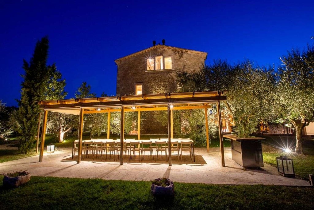 Elegant Italian villa with stone facade, arched windows, and manicured garden featuring a private pool surrounded by terra cotta planters