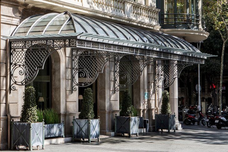 Classic sandstone facade of Majestic Hotel & Spa in Barcelona, featuring ornate balconies, grand windows and elegant French architecture