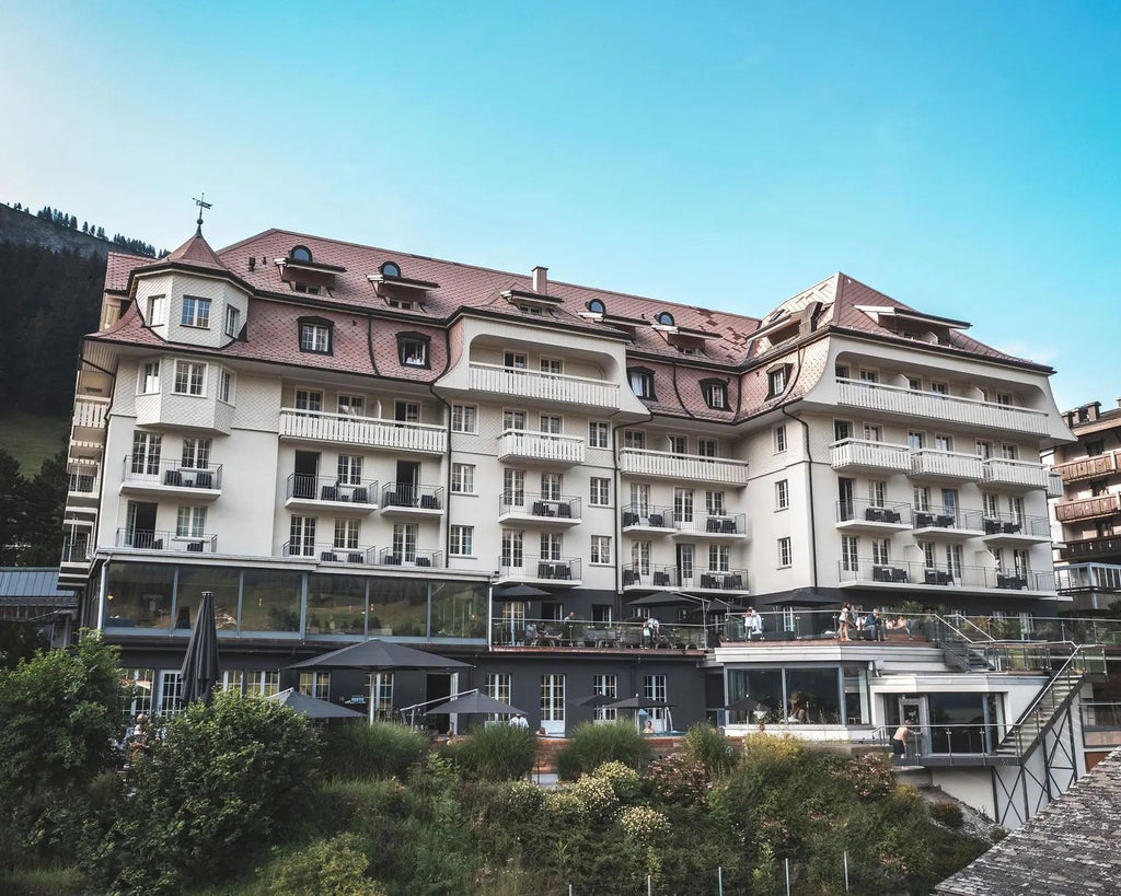 Luxurious alpine hotel with sleek modern design, floor-to-ceiling windows overlooking Swiss mountain landscape, minimalist white interior and scenic panoramic view