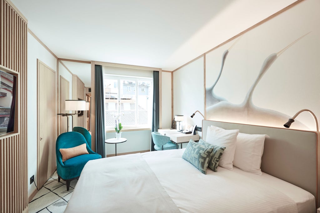 Elegant city-view queen room with plush white bedding, modern wood furnishings, and floor-to-ceiling windows overlooking Zurich's skyline.