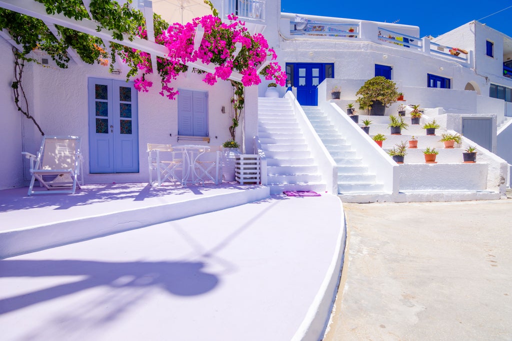 Sunset-lit Cycladic taverna with white-washed walls, elegant diners enjoying local Greek cuisine and wine on a panoramic terrace overlooking azure Aegean waters