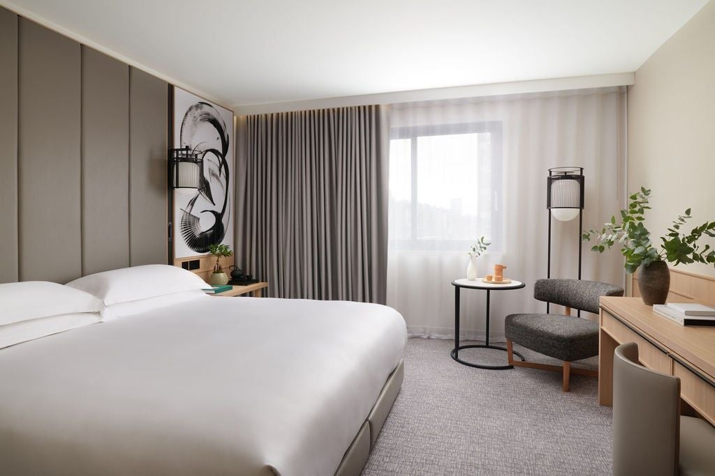 Spacious two-bedroom family suite with modern Japanese-inspired design, featuring elegant furnishings, plush beds, and sleek contemporary decor at Nobu Hotel London.