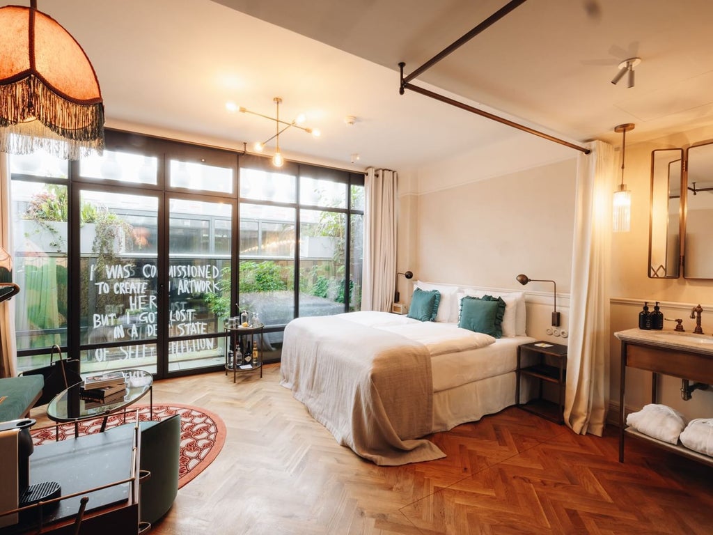 Minimalist Austrian hotel room with sleek wooden furniture, crisp white linens, large window, and elegant design in soft neutral tones