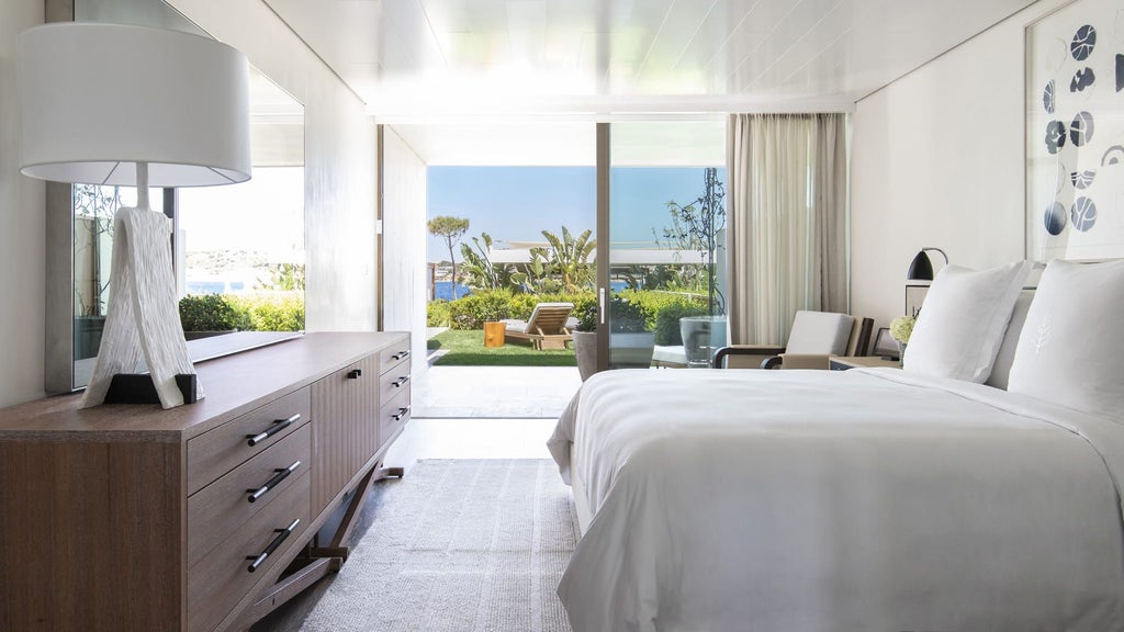 Elegant sea-view suite with private infinity pool, landscaped garden terrace and modern Mediterranean-style loungers overlooking Athens Riviera