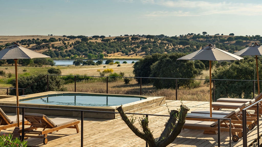 Contemporary luxury hotel exterior with sleek white walls, panoramic windows, and infinity pool overlooking scenic Portuguese countryside