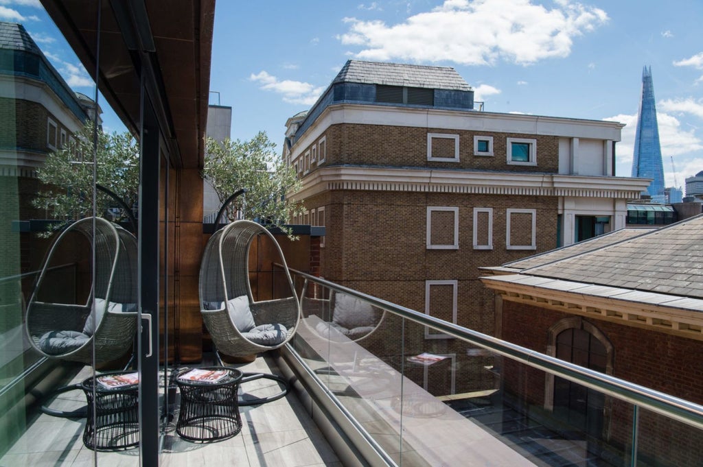 Elegant boutique hotel exterior with modern architectural design, featuring sleek glass windows and classic brick facade in central United Kingdom urban setting