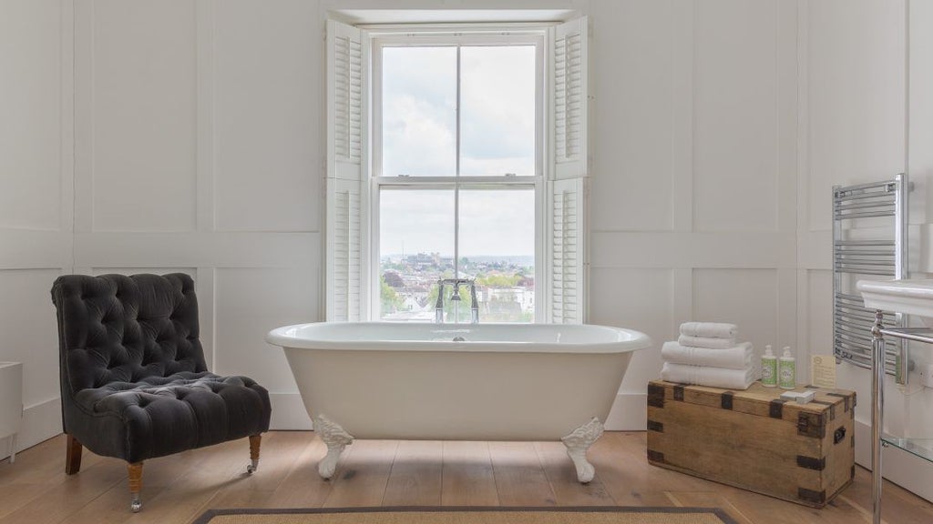 Elegant luxury double hotel room with modern bath and shower, featuring sophisticated decor and plush bedding in a refined United Kingdom accommodation