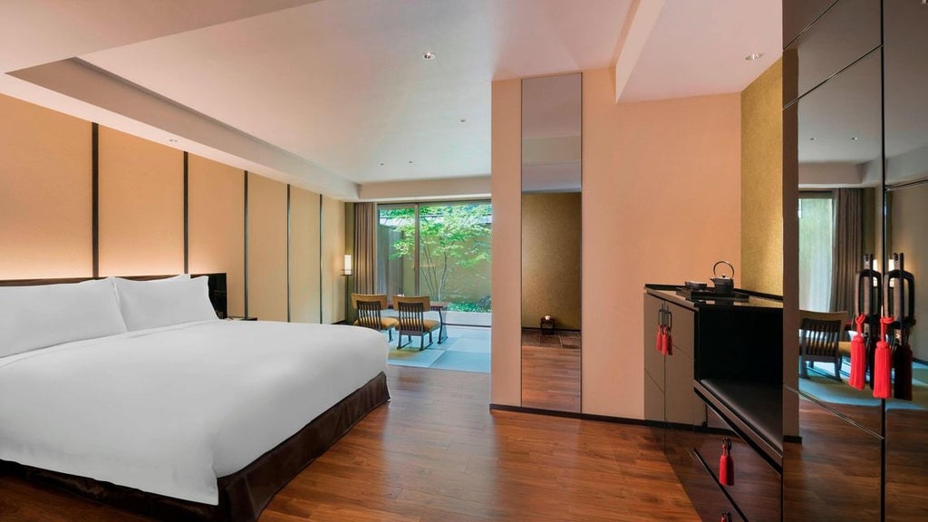 Elegant Suiran Presidential Suite overlooking traditional Japanese garden with luxurious wood-paneled interiors, plush furnishings, and seamless indoor-outdoor design