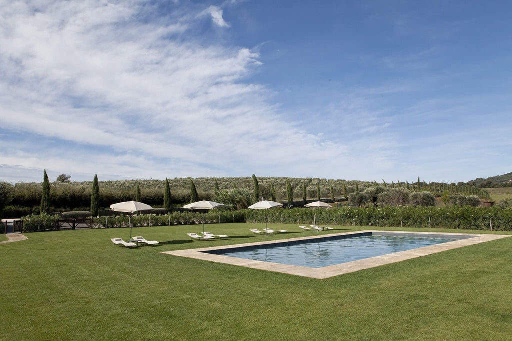 Rustic stone facade of elegant boutique hotel nestled in Tuscan countryside, with warm terracotta hues and lush green landscape surrounding luxurious Italian villa