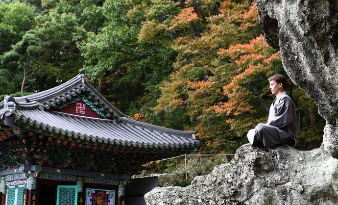 A guest enjoys a moment of contemplation in the temple grounds