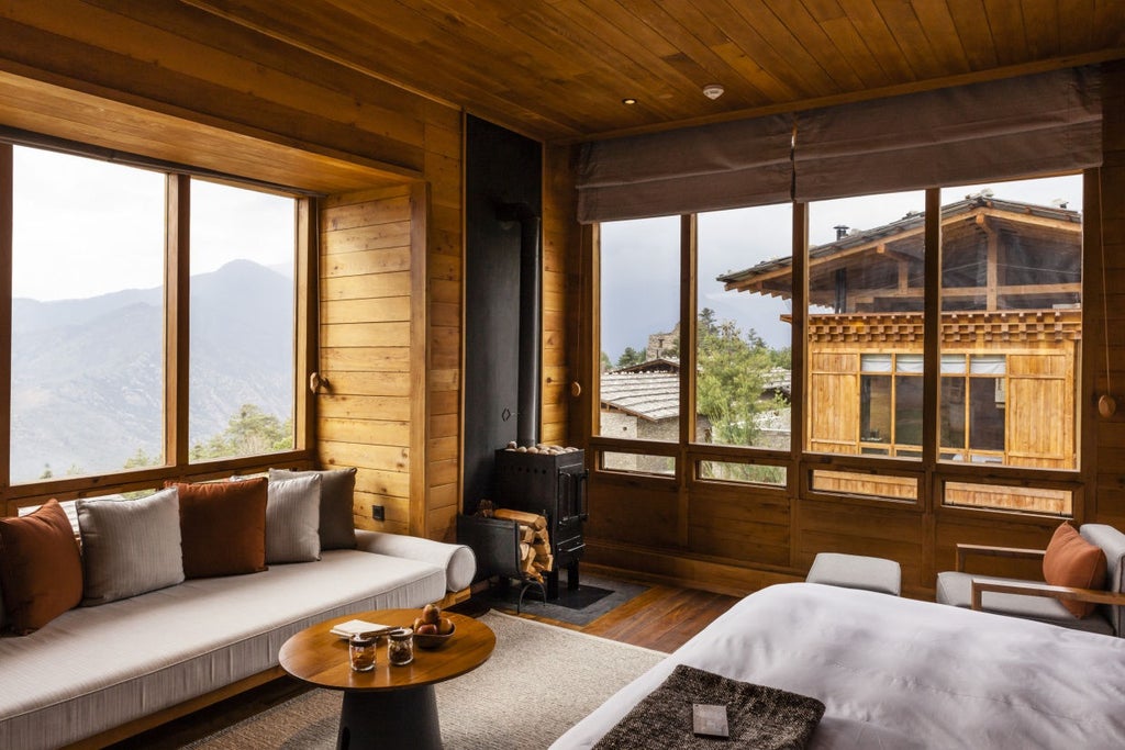 Luxurious mountain lodge with stone walls and wooden details nestled in Bhutan's Himalayas, surrounded by pine forest and misty peaks