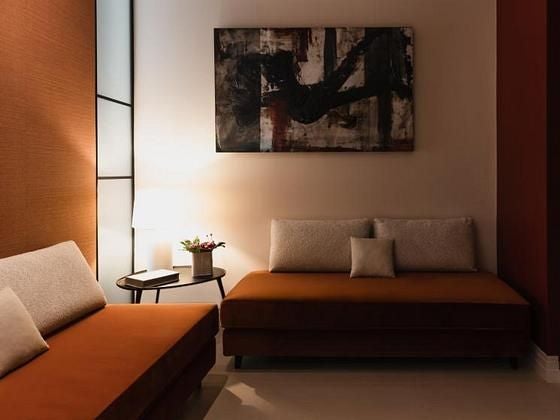 Elegant boutique hotel room in Rome, featuring plush white bedding, soft neutral tones, and chic minimalist design with panoramic window overlooking historic scenset.