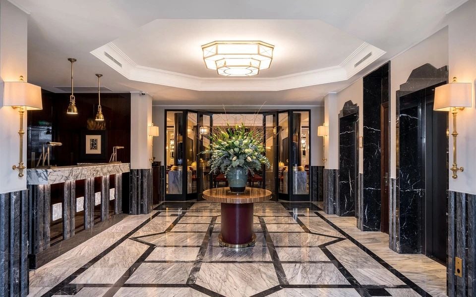 Elegant Art Nouveau facade of historic Palace Hotel in Porto, featuring ornate golden details and classic architectural splendor of early 20th-century Portuguese design