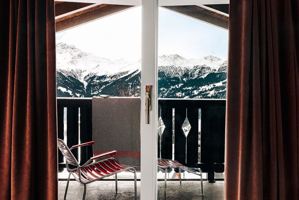 Modern luxury alpine chalet with sleek glass windows, wooden exterior, snow-capped mountain backdrop, minimalist design reflecting Swiss architectural elegance