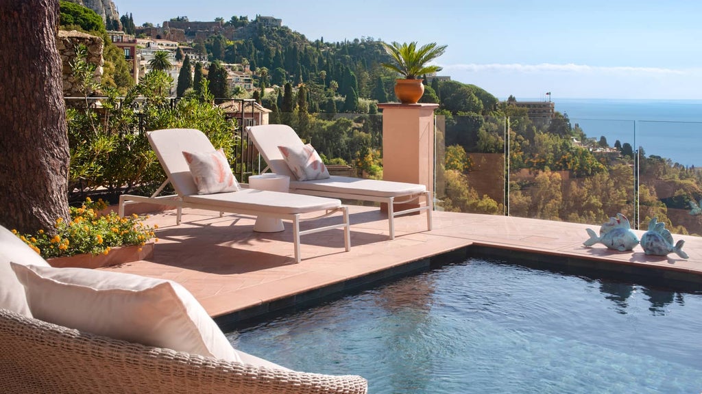 Luxurious cliffside hotel in Taormina, featuring stone architecture, manicured gardens and panoramic views of the Mediterranean Sea