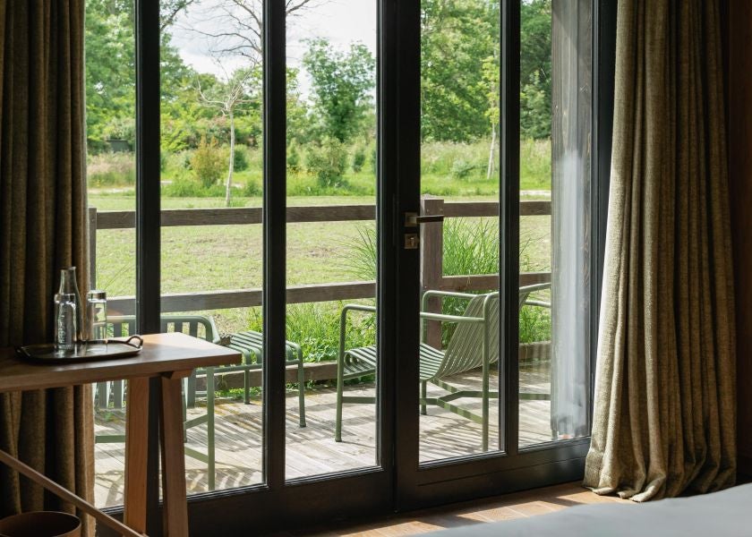 Elegant prestige room at Les Sources de Cheverny, featuring refined French decor, plush bedding, soft neutral tones, and sophisticated contemporary design