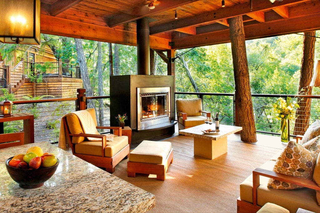 Luxurious wooden lodge with floor-to-ceiling windows nestled among tall trees, featuring a wrap-around terrace and natural stone accents