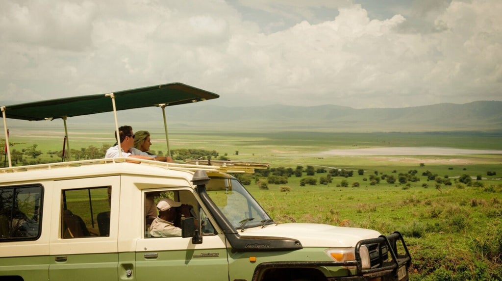 Luxurious safari lodge perched on Ngorongoro Crater's edge, with sweeping panoramic views of golden grasslands and distant volcanic landscapes in Tanzania.