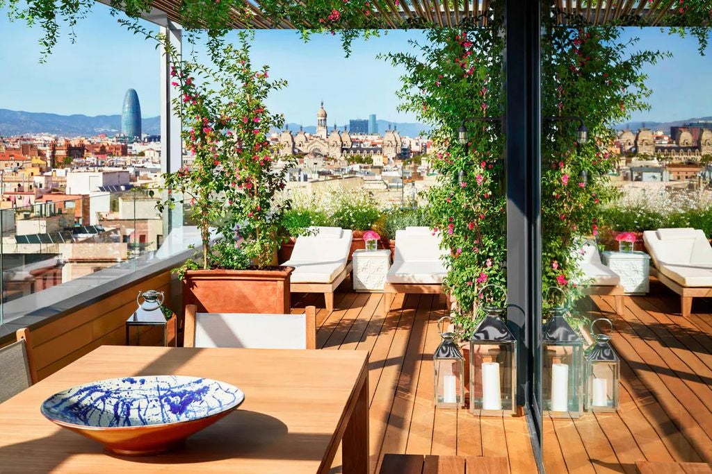 Elegant modern hotel facade with sleek glass windows, white stone columns and minimalist architectural details in Barcelona's Gothic Quarter