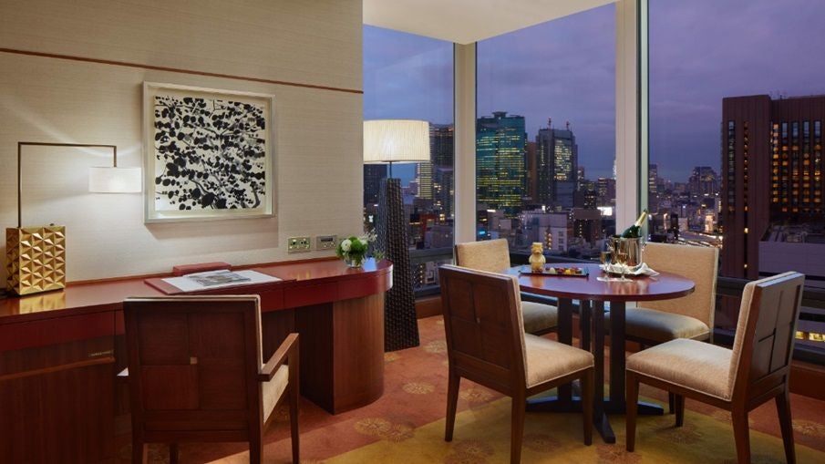 Luxurious executive suite with panoramic city views, minimalist Japanese design, plush king bed, and elegant marble bathroom at a high-end Tokyo hotel