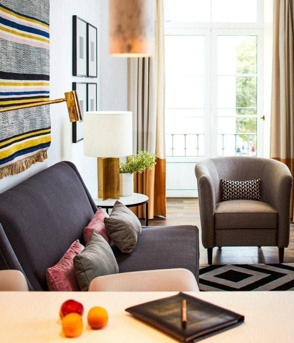 Luxurious one-bedroom suite at The Scenset Hotel & Spa, featuring elegant white decor, plush king bed, and panoramic city views of Portugal's landscape.