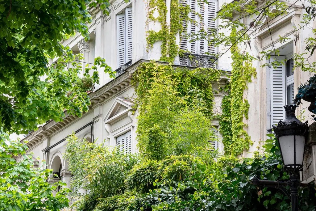 Elegant pink facade of luxurious boutique hotel in Paris, with Art Deco-inspired design and chic Parisian street scene visible