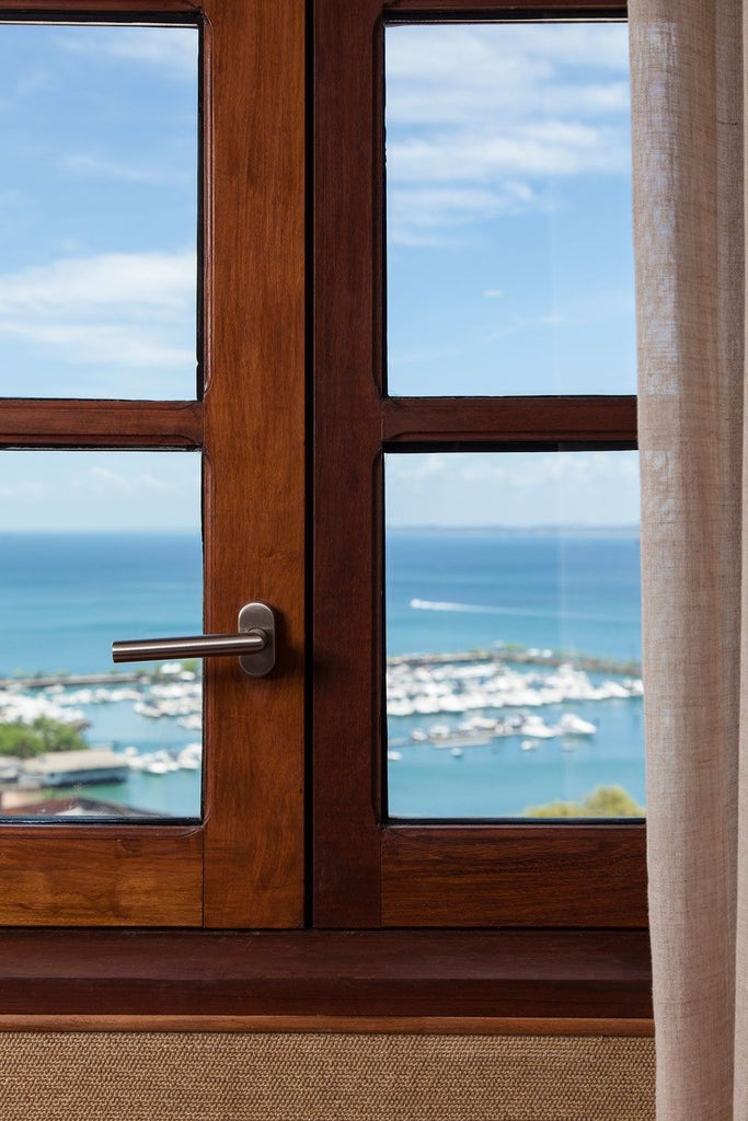 Luxurious Fasano hotel suite in Salvador, Brazil, with expansive ocean view, elegant contemporary design, and floor-to-ceiling windows overlooking turquoise coastline