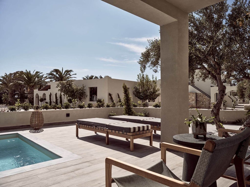 Luxurious king suite with private pool overlooking azure Aegean waters at scenic beachfront resort in Crete, Greece, featuring modern minimalist design