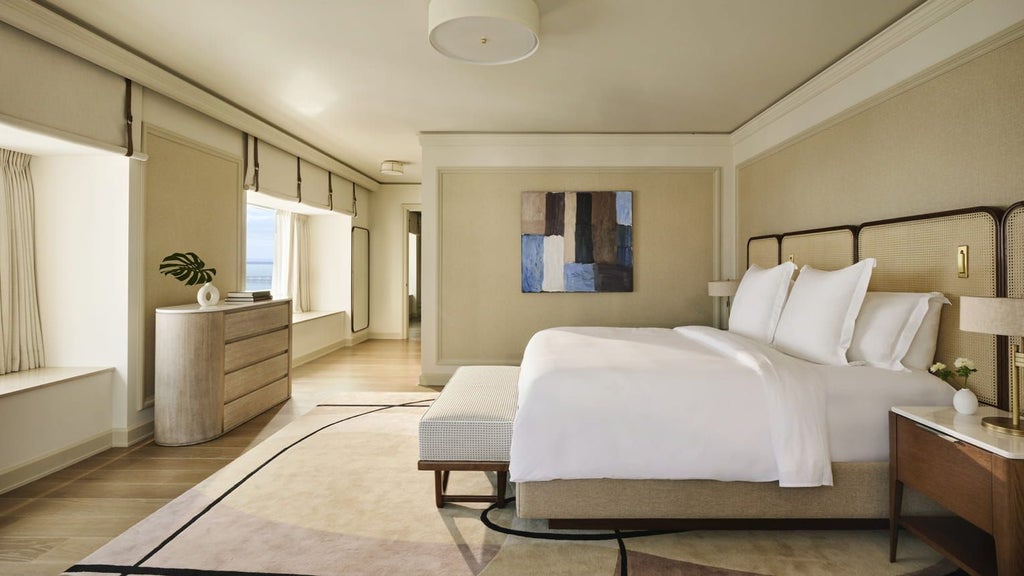 Luxurious Premier One-Bedroom Suite at Four Seasons Miami with sweeping bay views, modern furnishings, and elegant floor-to-ceiling windows overlooking turquoise waters