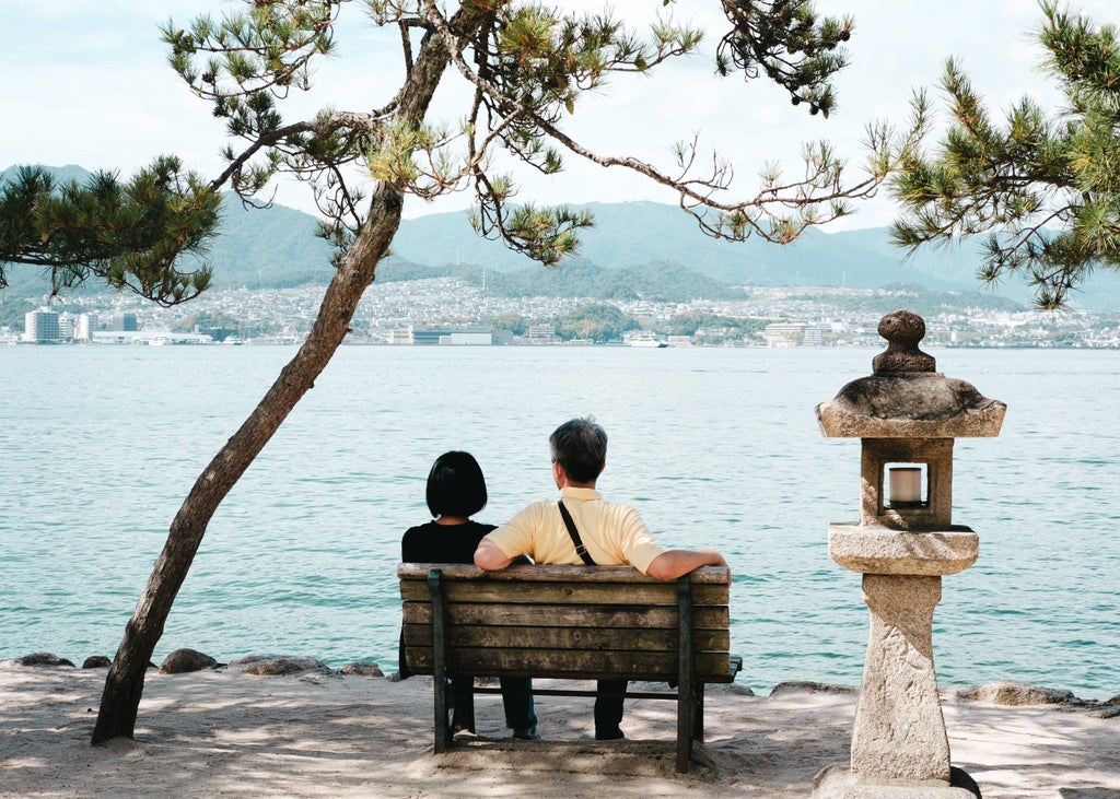 Iconic vermillion Floating Torii Gate of Itsukushima Shrine standing majestically in the sea at sunset, Miyajima Island, Japan