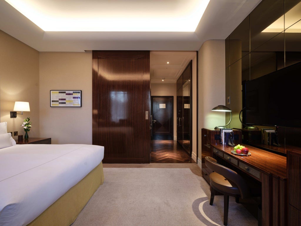 Elegant premier hotel room at Scenset Mayfair, featuring plush king bed, refined neutral decor, soft lighting, and sophisticated contemporary design elements