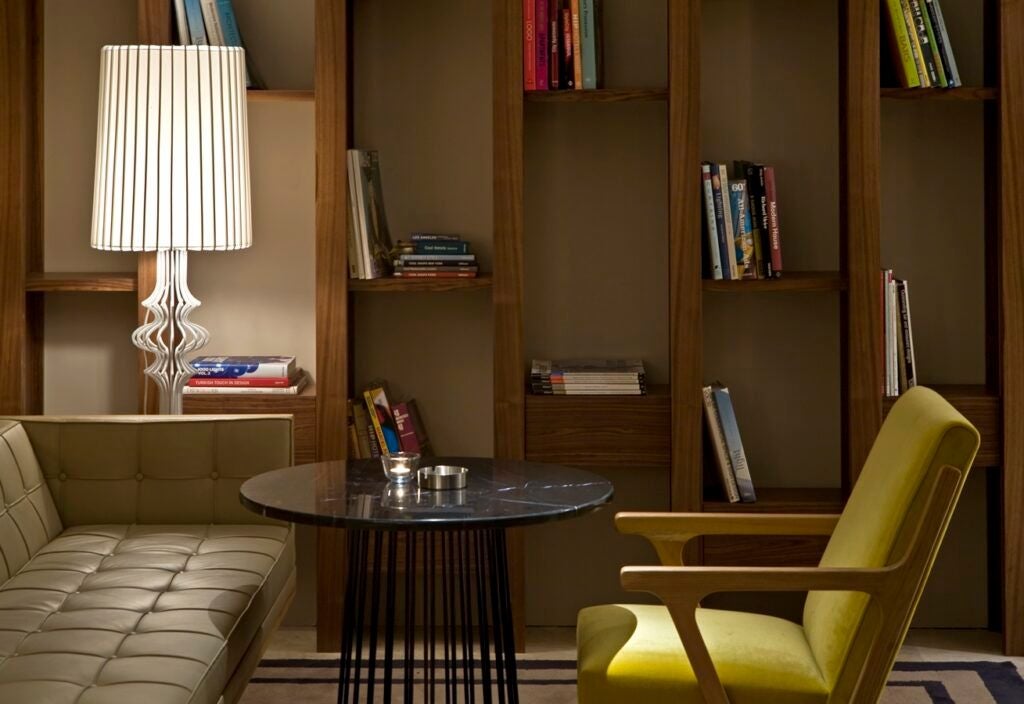 Luxurious boutique hotel in Istanbul's trendy Beyoğlu district, featuring modern design with sleek lines, warm wood accents, and elegant urban aesthetic