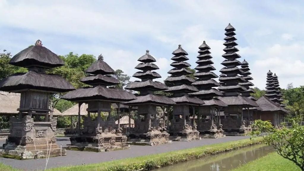 Lush green UNESCO rice terraces of Jatiluwih with traditional Balinese temple, guided trekking path revealing scenic Indonesian landscape and cultural heritage