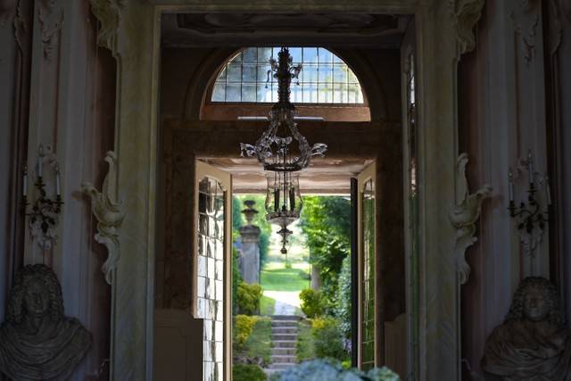 Luxurious lakefront hotel with elegant Art Nouveau facade, surrounded by manicured gardens, overlooking Lake Como in northern Italy