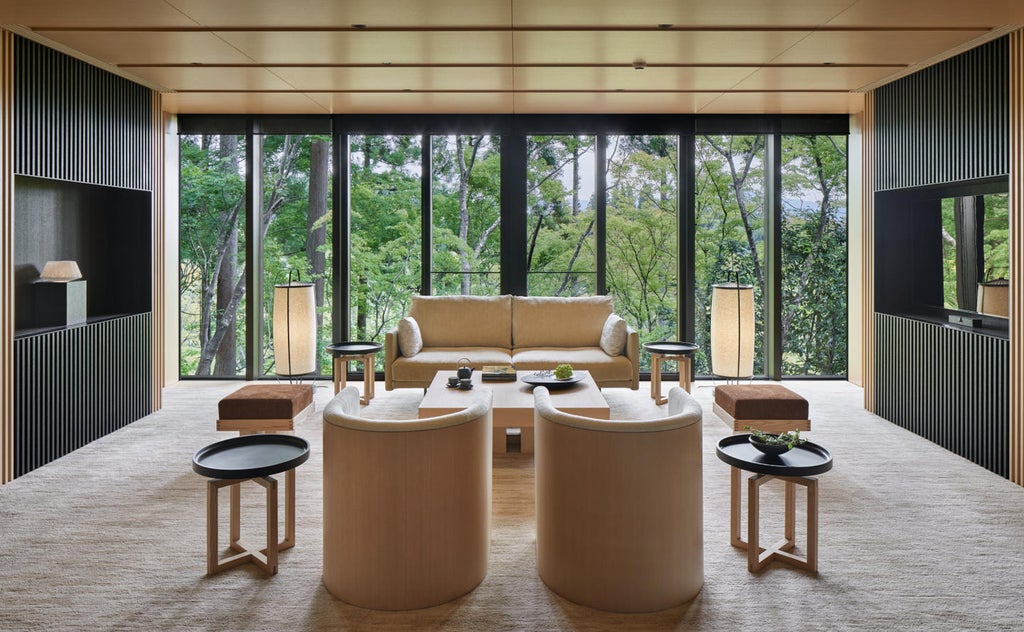 Traditional Japanese minimalist hotel exterior with stone pathways winding through serene moss gardens and towering bamboo forest