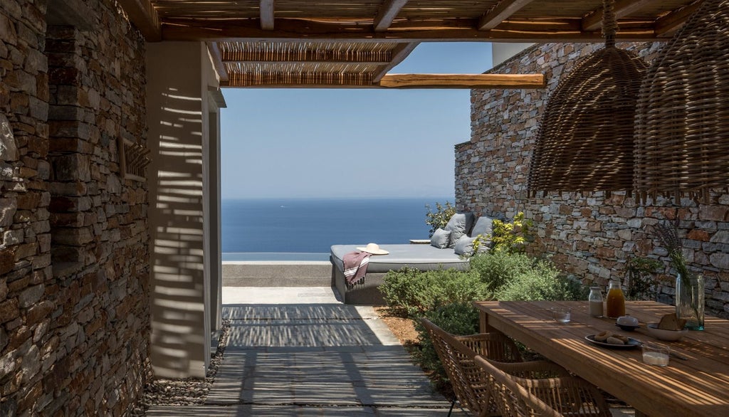 Elegant white-washed Cycladic hotel room with minimalist design, blue sea view, and private balcony overlooking scenic Greek landscape at Verina Astra, Sifnos