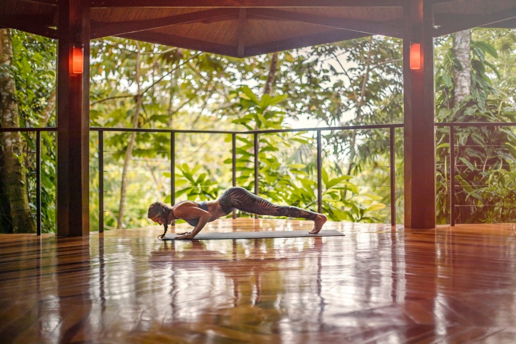 Private terrace with infinity plunge pool overlooking lush rainforest, featuring contemporary lounge chairs and tropical plants at Nayara Springs