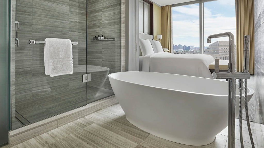 Luxurious Four Seasons Executive Suite with modern design, panoramic city views, elegant furnishings, and sophisticated neutral color palette in Boston