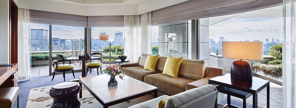 Spacious Garden Suite with elegant Japanese-inspired design, featuring minimalist furnishings, soft neutral tones, and panoramic views of manicured landscape