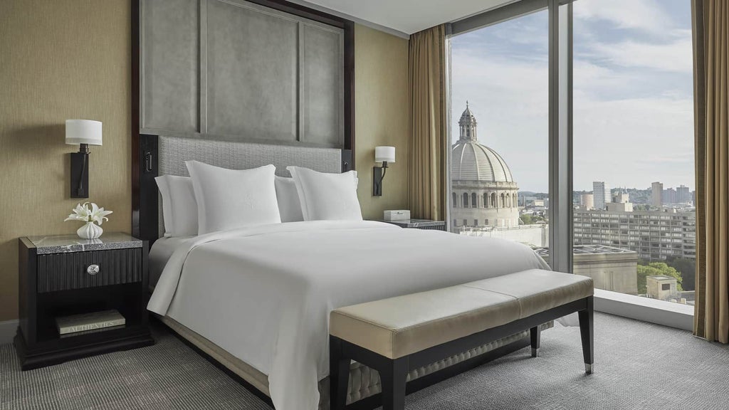 Spacious Four Seasons Executive Accessible Suite with elegant king bed, modern furnishings, and city view, featuring wheelchair-friendly design and luxurious amenities