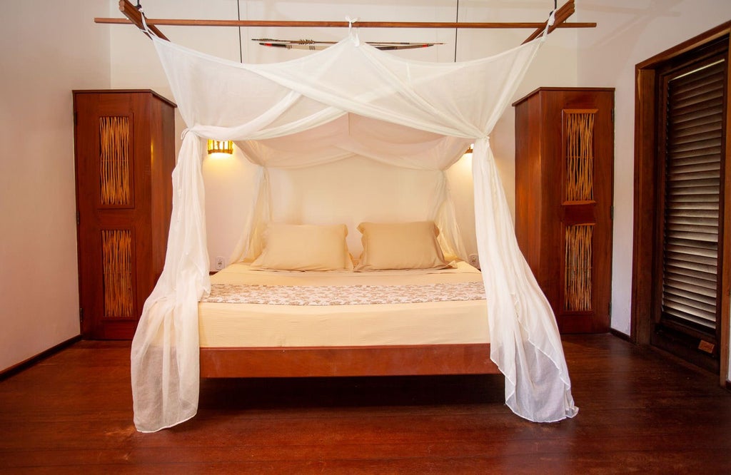 Elegant garden-view room at La Ferme de Georges River Lodge, featuring lush greenery, warm wood furnishings, and serene Brazilian countryside backdrop