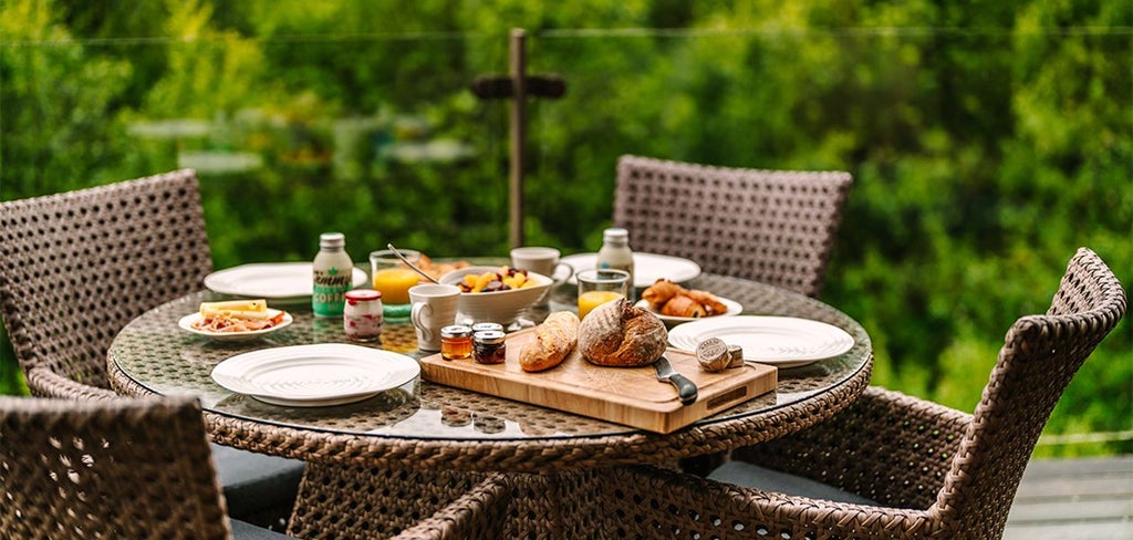 Luxurious tree house suite with floor-to-ceiling windows, modern rustic decor, and woodland view at Chewton Glen Hotel & Spa nestled in scenic United Kingdom countryside